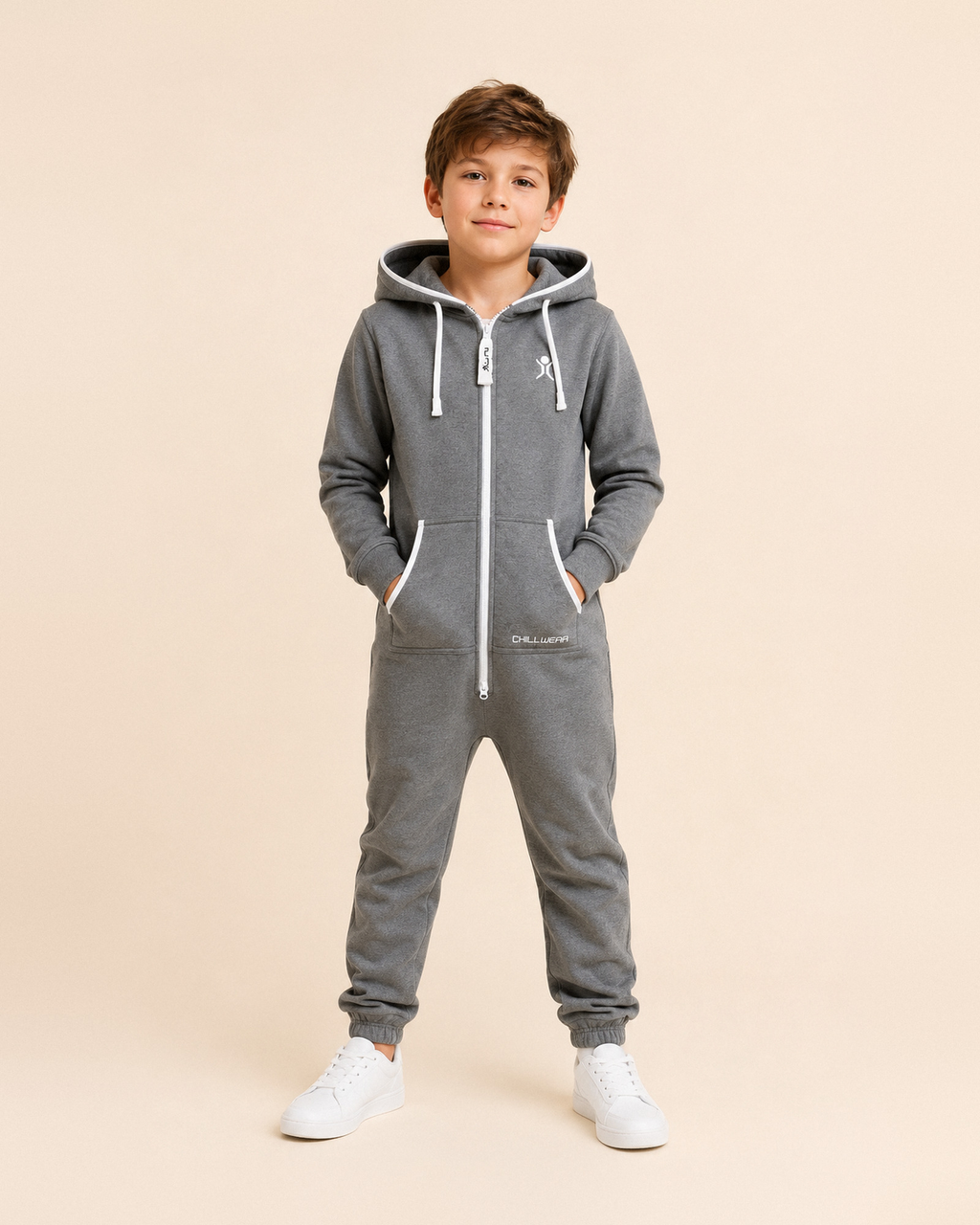 Charcoal Lounger Kids, charcoal grey fleece kids onesie, front view on a boy | Unichill kids onesie designed in Calgary