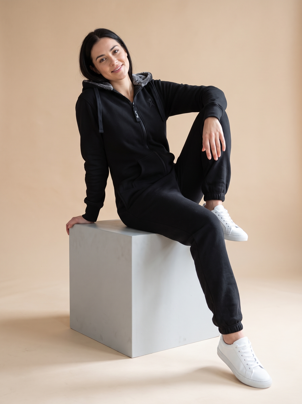 Stealth Black, black fleece onesie with faux fur hood, lifestyle photo | Unichill adult unisex jumpsuit designed in Calgary