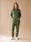 Evergreen Zip-Up, green hoodless fleece onesie, front view on a woman | Unichill adult unisex jumpsuit designed in Calgary