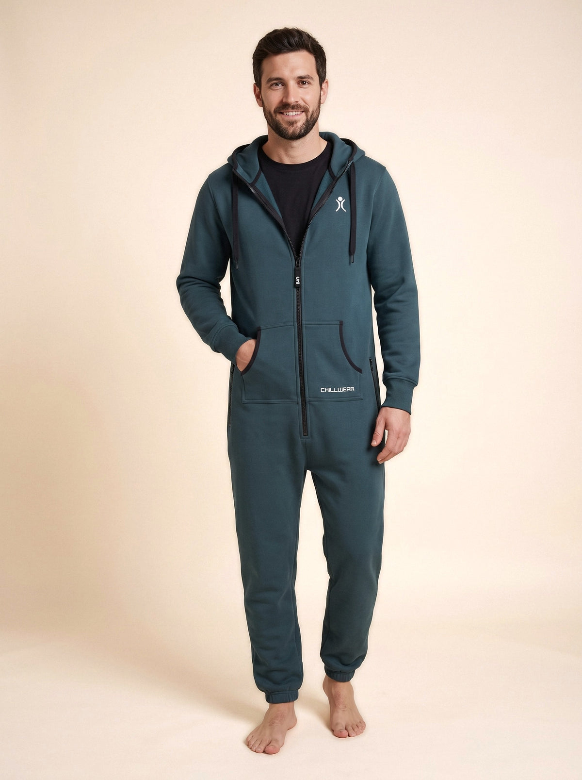 Transformative Teal onesie on a man, front view on a beige background | Unichill adult unisex fleece onesie designed in Calgary