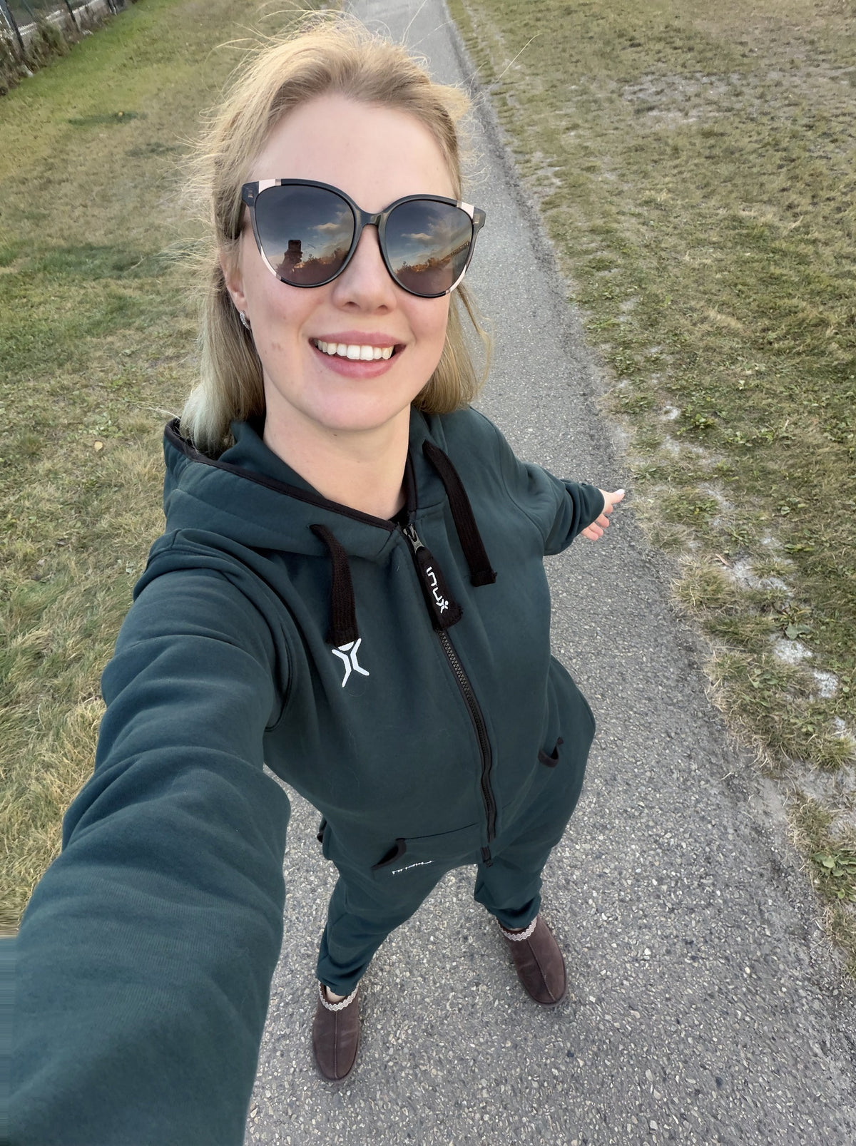 Valeriia taking a selfie in the Transformative Teal onesie on an autumn walk | Unichill adult unisex fleece onesie designed in Calgary
